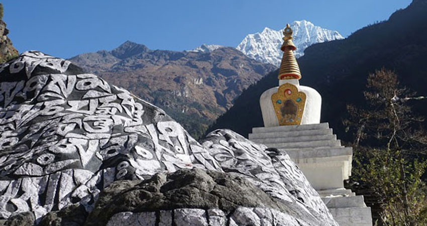 Stupa and Buddhist tablets Khangtega on the background.